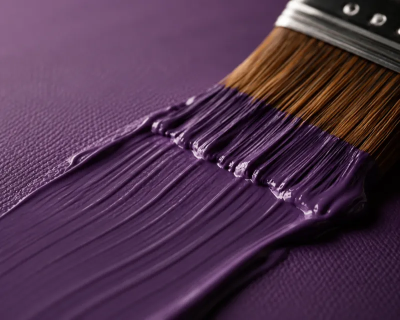 A close-up shot of luxurious, thick paint being applied to a canvas